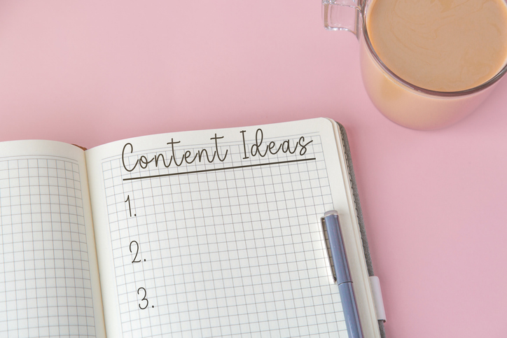 open-notebook-with-handwritten-title-text-content-ideas-blue-pen-and-cup-of-coffee-on-pink-background-flat-lay-for-blogging-or-planning-creativity-and-productivity-concept