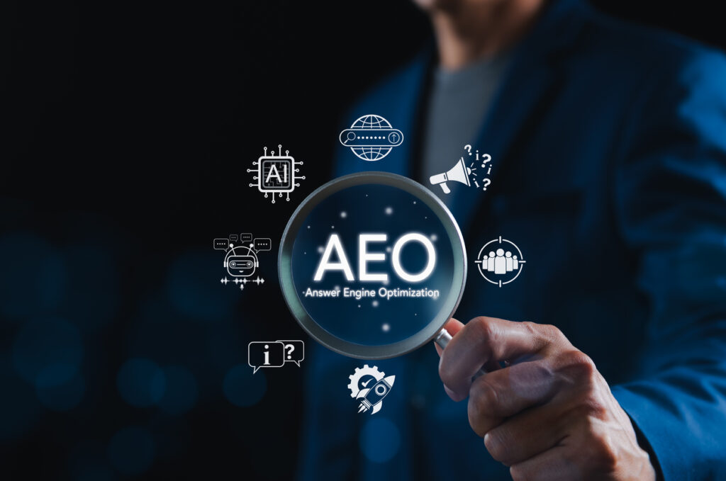 aeo-answer-engine-optimization-strategy-concept-businessman-holding-magnifying-glass-with-aeo-icons-representing-artificial-intelligence-chatbots-search-optimization-and-marketing-strategy
